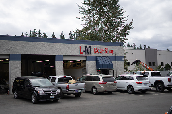Customer vehicles in the L-M Body Shop parking lot in Totem Lake, Kirkland